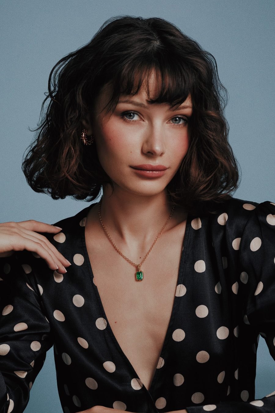 Model in a polka dot top wearing the Kathryn Emerald Pendant